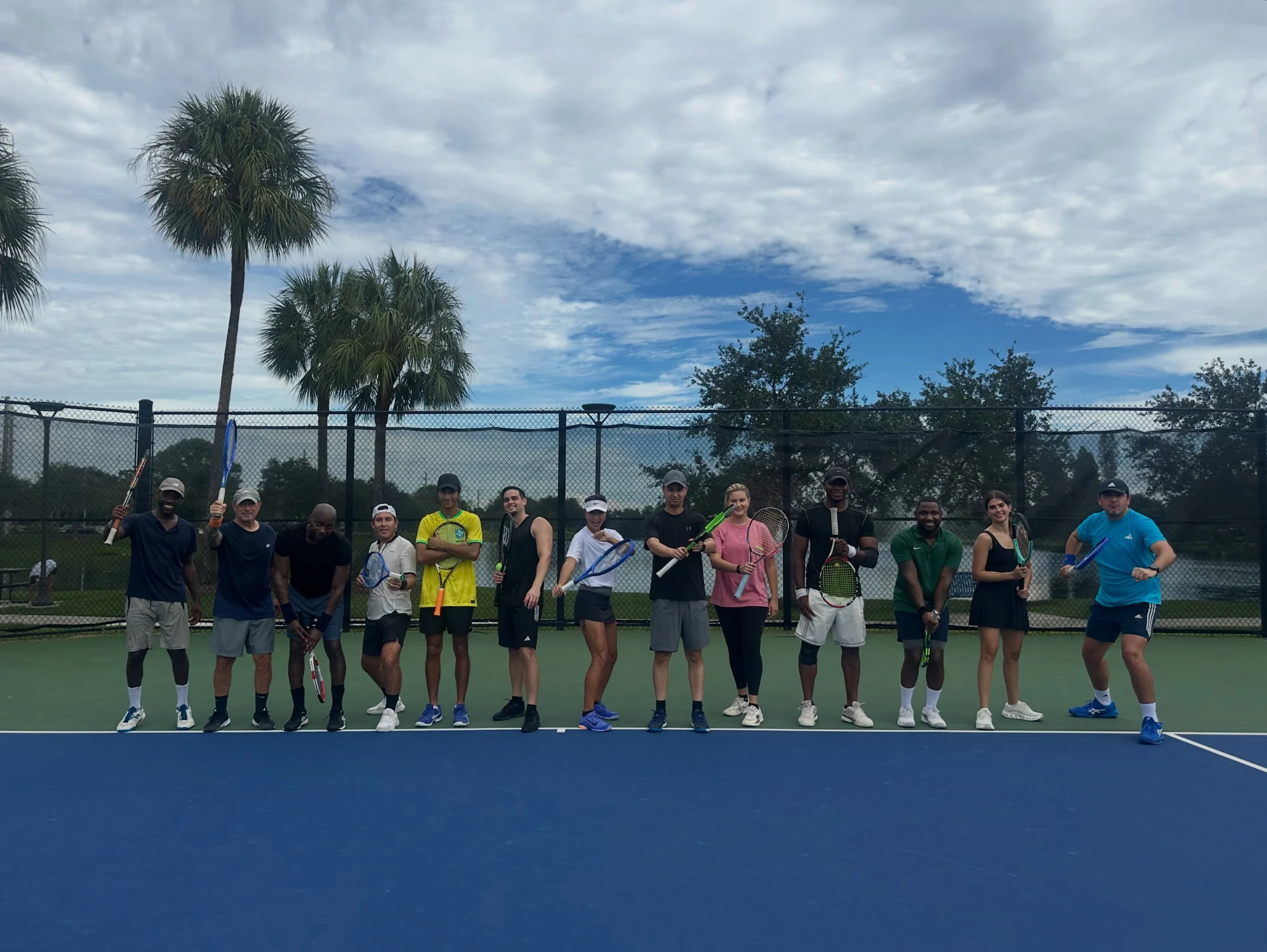 Florida Tennis Partners gathering on a blue court at Windmill Park